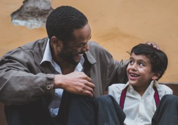 Father sitting and smiling with son